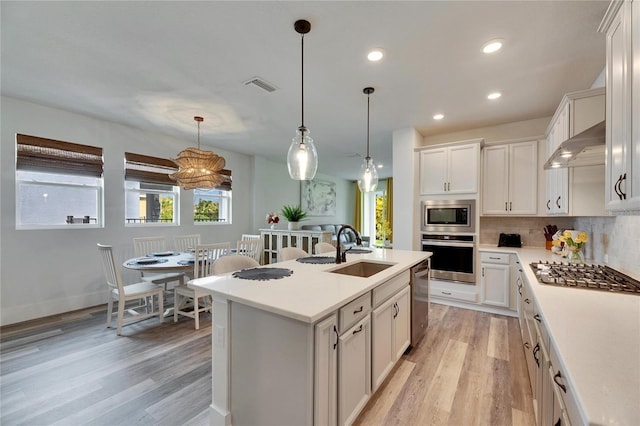 kitchen featuring a healthy amount of sunlight, visible vents, stainless steel appliances, and a sink