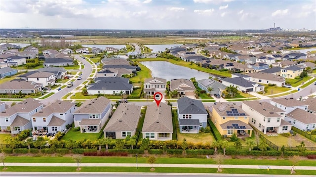 drone / aerial view with a water view and a residential view