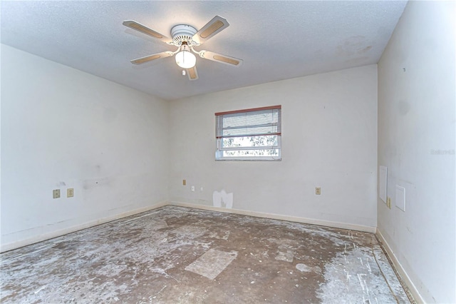 empty room with a textured ceiling, ceiling fan, and baseboards