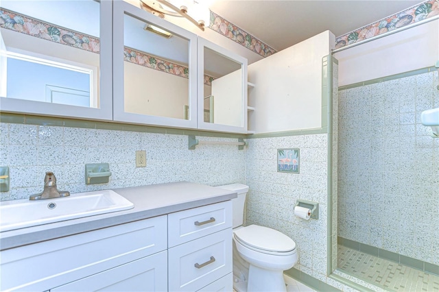 full bath with toilet, a stall shower, tile walls, and vanity