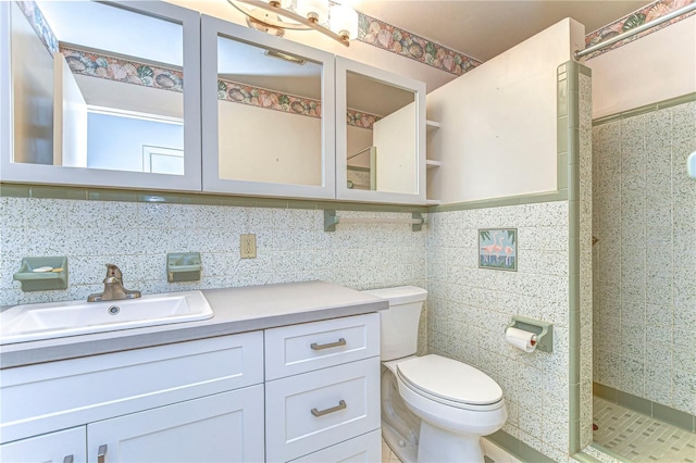 bathroom with a stall shower, tile walls, toilet, and vanity