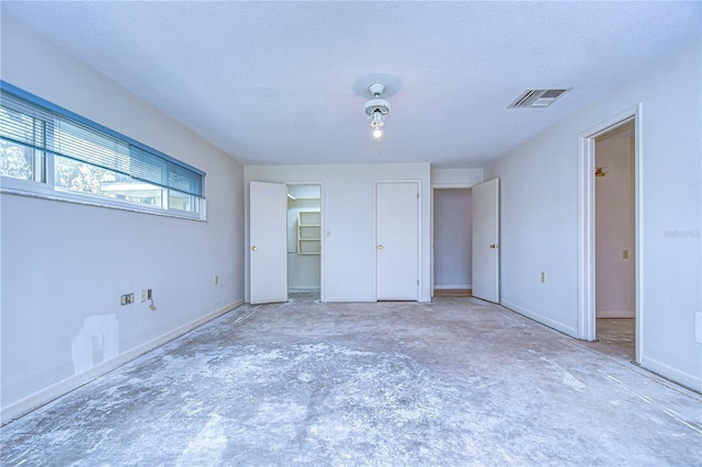 unfurnished bedroom featuring visible vents and a textured ceiling