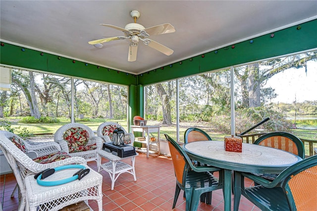 sunroom featuring a ceiling fan