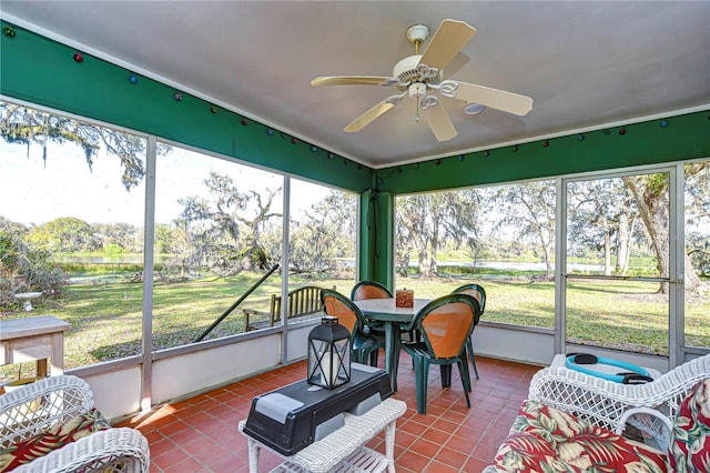 sunroom featuring ceiling fan