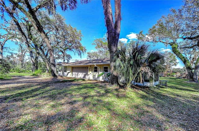 view of front of home with an attached garage and a front yard