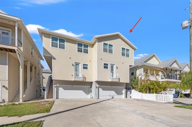 view of front facade featuring stairs, driveway, and a garage