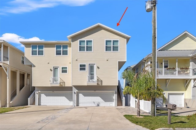 view of front facade featuring a garage, driveway, and stairway