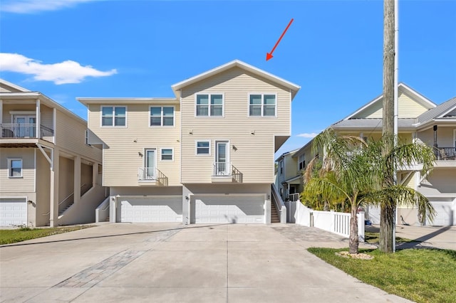 view of front facade with an attached garage, driveway, and stairs