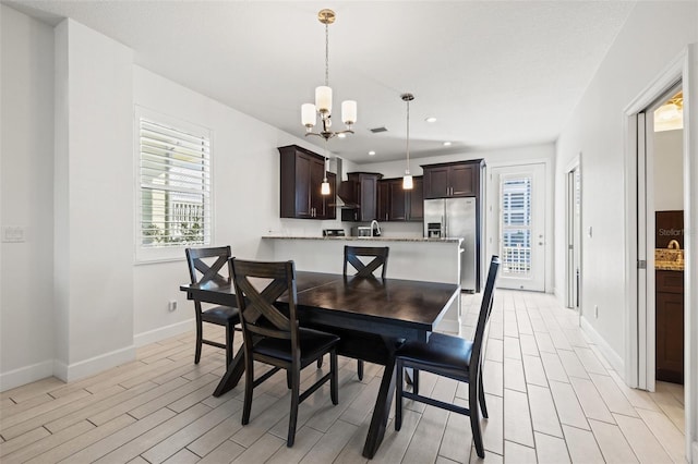 dining area featuring a notable chandelier, recessed lighting, visible vents, light wood-type flooring, and baseboards