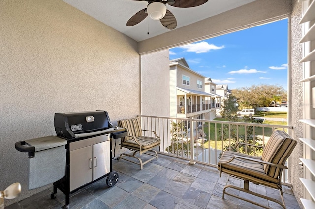 balcony with area for grilling, a residential view, and a ceiling fan