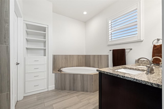 bathroom with a garden tub, recessed lighting, a closet, and vanity