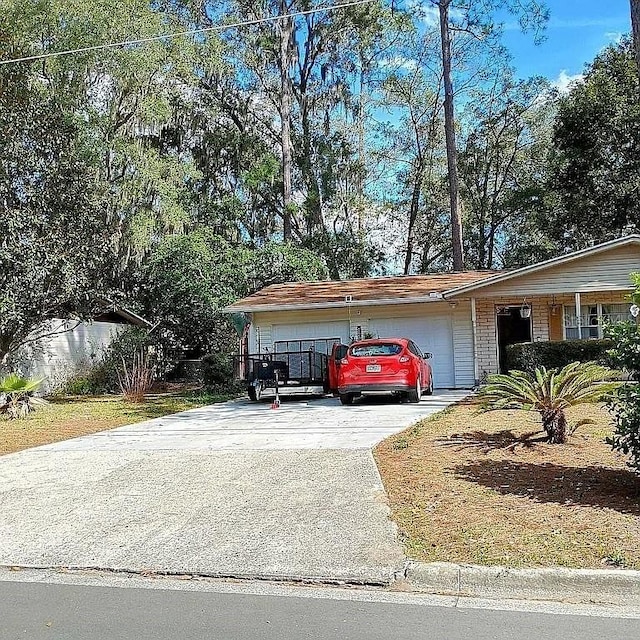 exterior space featuring brick siding, driveway, and an attached garage