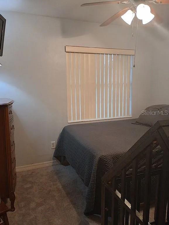 bedroom featuring carpet floors, ceiling fan, and baseboards