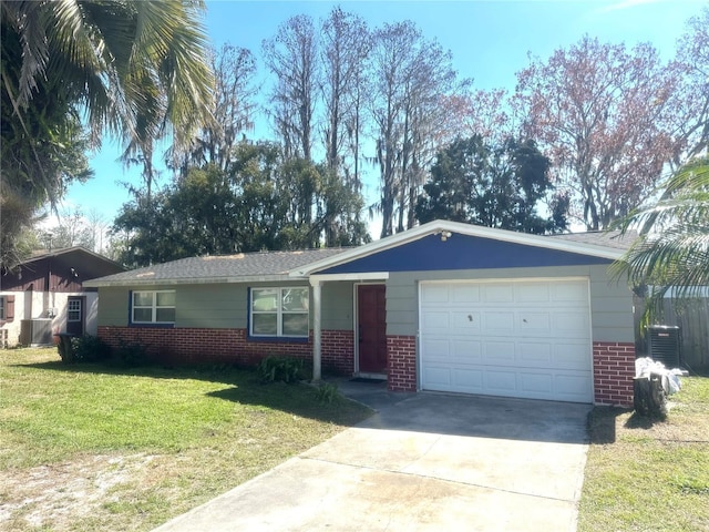 single story home featuring a garage, concrete driveway, a front lawn, and brick siding