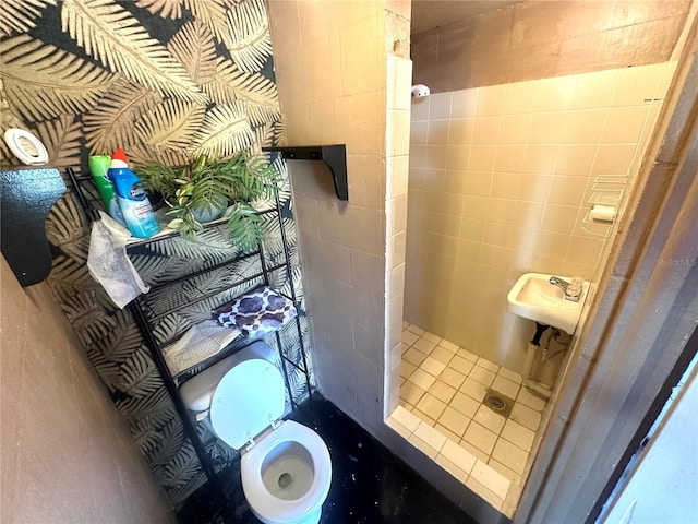 bathroom with a shower stall and toilet