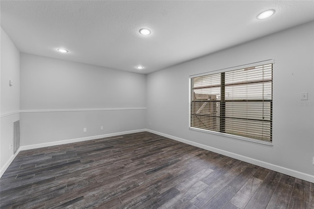 spare room with recessed lighting, baseboards, and wood finished floors