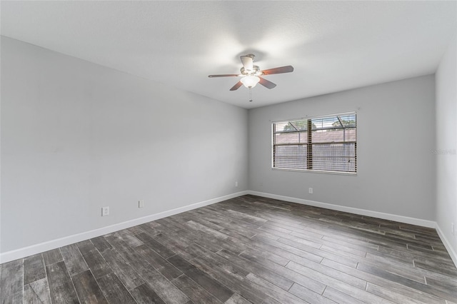 unfurnished room featuring dark wood-style floors, baseboards, and a ceiling fan