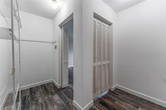 hallway with baseboards and wood finished floors