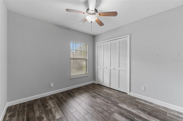 unfurnished bedroom featuring a closet, wood finished floors, and baseboards