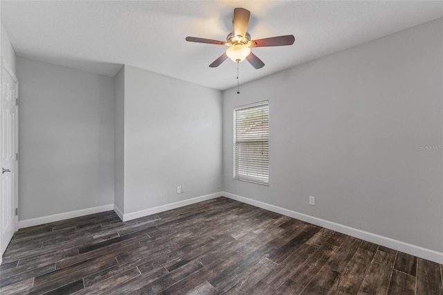 empty room with dark wood-style floors, baseboards, and a ceiling fan