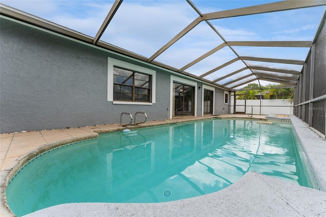 view of swimming pool with a patio, a lanai, and a fenced in pool