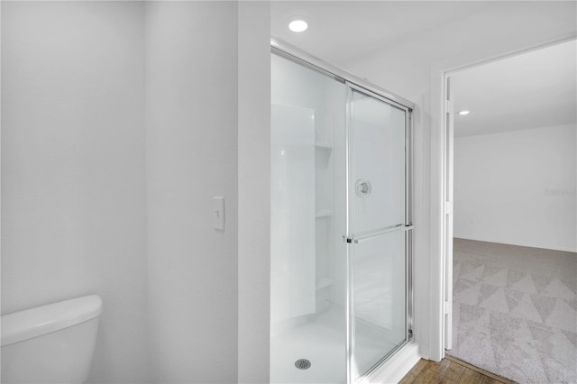 bathroom with toilet and a shower stall