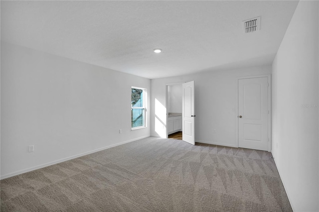 unfurnished bedroom featuring baseboards, visible vents, and carpet flooring