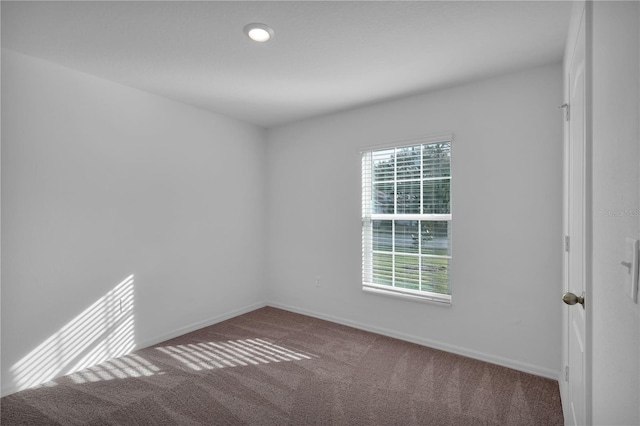 empty room with carpet floors and baseboards