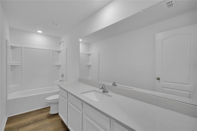 bathroom featuring visible vents, vanity, toilet, and wood finished floors