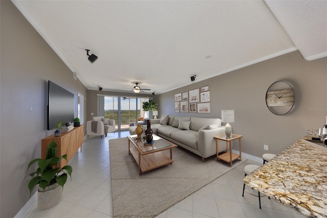 living room with light tile patterned floors, baseboards, ornamental molding, and ceiling fan