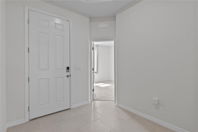 interior space with light tile patterned floors, visible vents, and baseboards