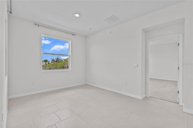 unfurnished room featuring visible vents and baseboards