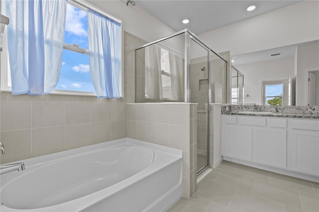 full bathroom with a stall shower, tile patterned flooring, vanity, a bath, and recessed lighting