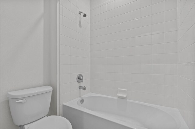 bathroom featuring toilet and bathing tub / shower combination