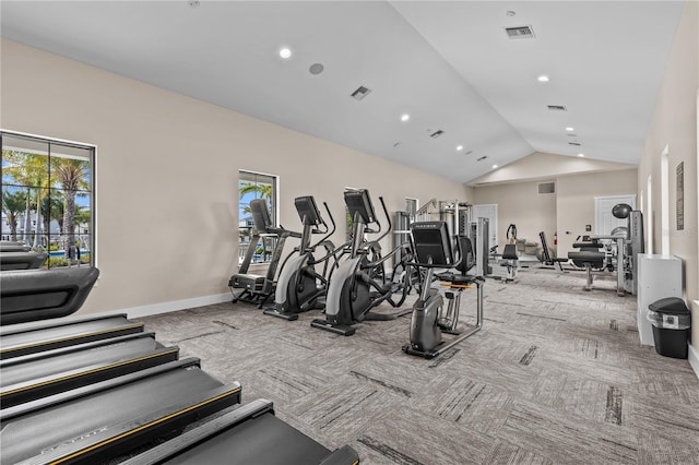 gym with vaulted ceiling, carpet flooring, and visible vents