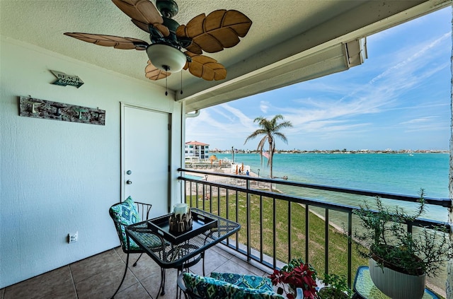 balcony with a water view and ceiling fan