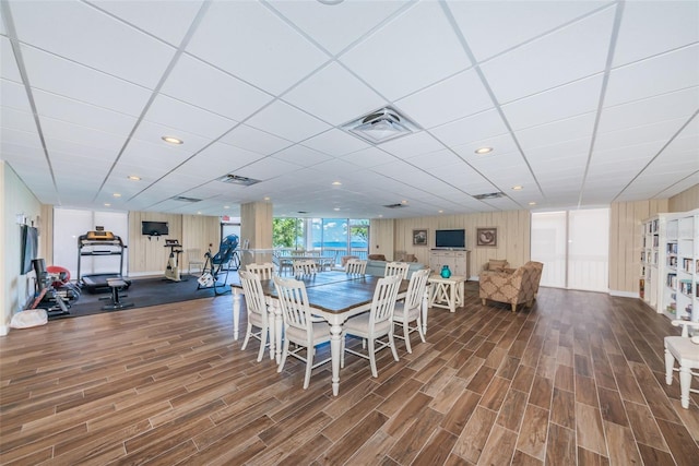 dining room with a paneled ceiling, visible vents, and wood finished floors