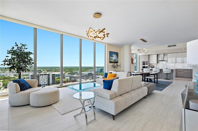 living area with expansive windows, visible vents, and a notable chandelier