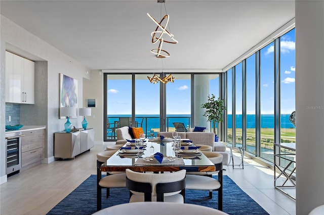 dining area with expansive windows, beverage cooler, a healthy amount of sunlight, and an inviting chandelier