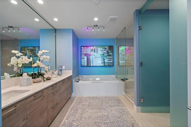 bathroom featuring a garden tub, a sink, visible vents, double vanity, and a stall shower