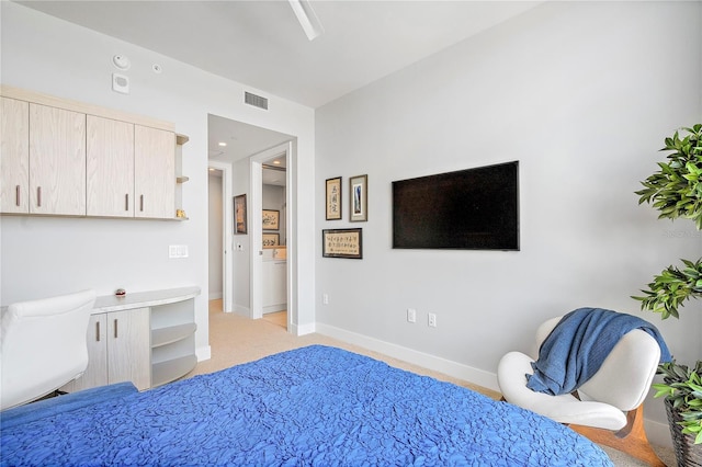 bedroom with light carpet, visible vents, and baseboards