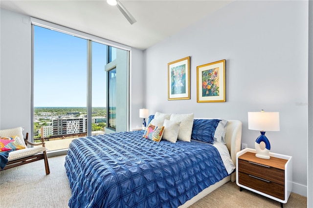 bedroom with baseboards, floor to ceiling windows, ceiling fan, and carpet flooring