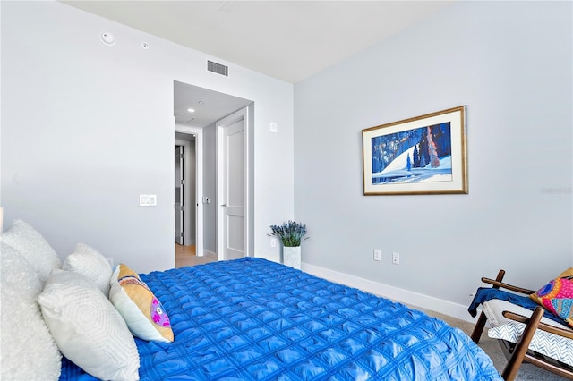 bedroom featuring baseboards and visible vents