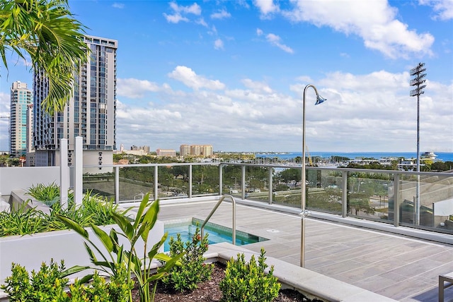 balcony with a hot tub and a city view