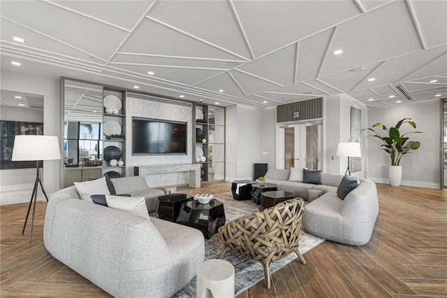 living area with parquet floors, baseboards, and recessed lighting