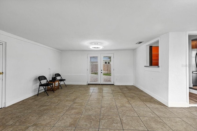 interior space featuring french doors, tile patterned floors, visible vents, and baseboards