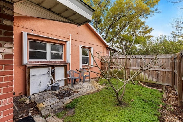 view of yard with fence and a patio