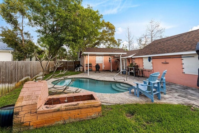 view of pool featuring a fenced backyard, a fenced in pool, and a patio