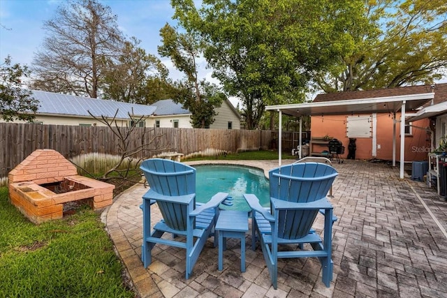 view of swimming pool with a patio and a fenced backyard