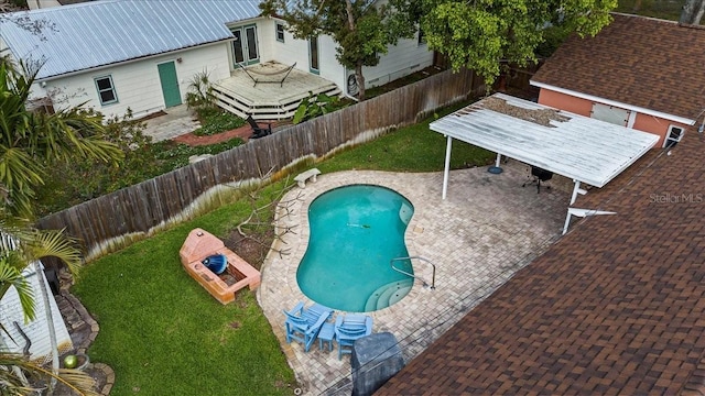 view of swimming pool featuring a fenced backyard, french doors, a lawn, a fenced in pool, and a patio area